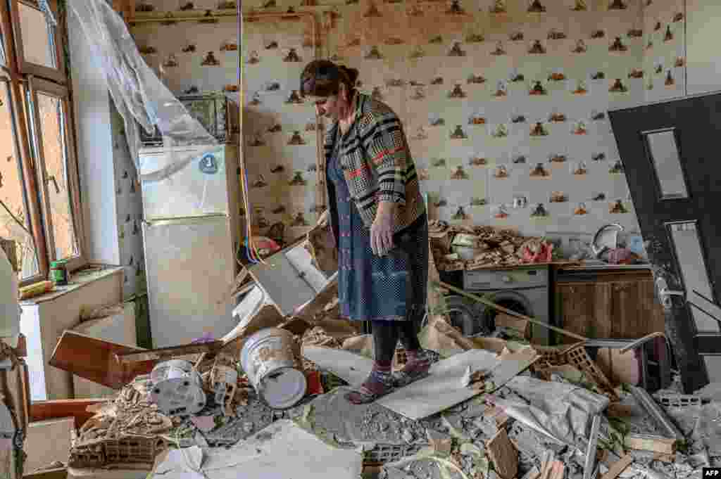 Khatira Celilova walks in the kitchen of her destroyed apartment in the Azerbaijani town of Tartar&nbsp; following an October 10, 2020 ceasefire in the fighting over the breakaway region of Nagorno-Karabakh and seven surrounding Armenian-occupied territories. Residents had evacuated the town, located just to the east of Nagorno-Karabakh, after heavy shelling.&nbsp;
