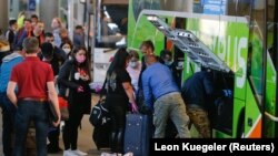 Seasonal workers from Eastern Europe, with special permission to enter Germany during the COVID-19 pandemic, board a bus after their arrival in Duesseldorf on April 9, 2020. 