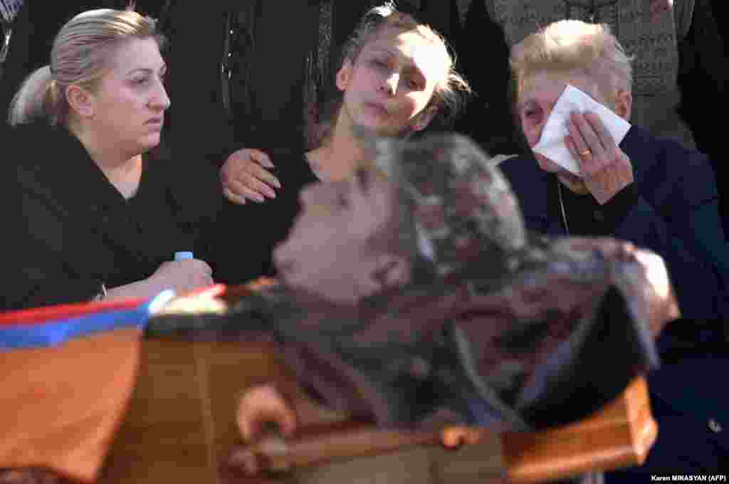 During an October 10 funeral in Yerevan&#39;s Yerablur military cemetery, relatives respond to the death of Armenian soldier Vazgen Aslanian, one of 542 Armenian armed forces personnel killed since fighting with Azerbaijan over the breakaway region of Nagorno-Karabakh resumed on September 27. &nbsp;