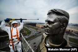 A worker cleans Moscow's statue of Yuri Gagarin, the first person to fly into outer space, ahead of Russia's 2019 Cosmonautics Day.