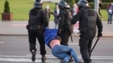BELARUS -- Belarusian law enforcement members detain a man during an opposition protest following the inauguration  of Belarusian President Lukashenka in Minsk, September 23, 2020