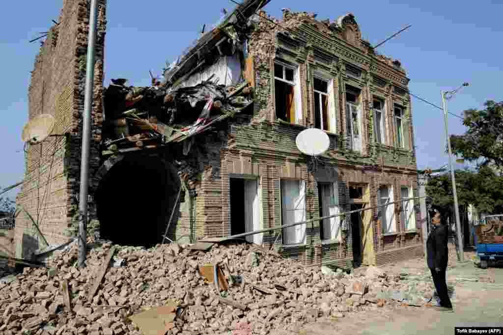 AZERBAIJAN -- A local man looks at a residential building damaged by shelling during the ongoing military conflict between Armenia and Azerbaijan over the breakaway region of Nagorno-Karabakh, in the city of Ganca, on October 27, 2020