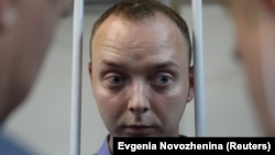 Ivan Safronov, a former journalist who works as an aide to the head of Russia's space agency Roskosmos, stands inside the defendants' cage at a July 7, 2020 court hearing in Moscow on charges of treason.
