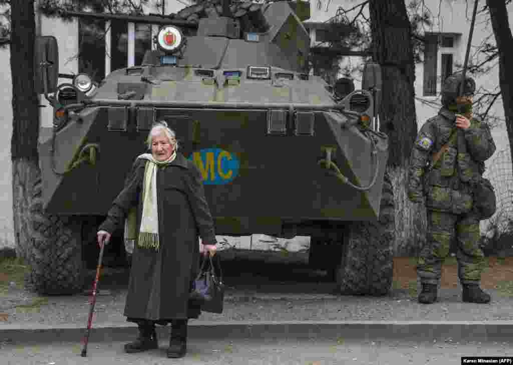 Five days before the arrival of Azerbaijani troops on December 1, 2020, Margarita Khanaghian, 81, walks past an armored personnel carrier for Russian peacekeepers in the town of Lachin (Berdzor). How many of the town&#39;s ethnic Armenian residents opted to stay despite the town&#39;s return to Azerbaijani control is unknown.&nbsp;