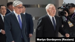 Then Interim Kazakh President Qasym-Zhomart Toqaev (left) and former President Nursultan Nazarbaev attend the 2019 Astana Economic Forum in Nur-Sultan.