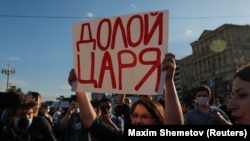 Carrying a sign that declares, in reference to President Vladimir Putin, "Down with the tsar," municipal deputy Yulia Galyamina protests in downtown Moscow on July 1, 2020 against amendments to Russia's constitution.