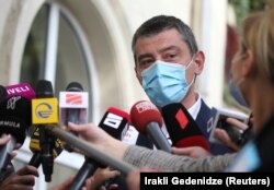 Georgian Prime Minister Giorgi Gakharia speaks to the media as he visits a polling station in Tbilisi on October 31, 2020.