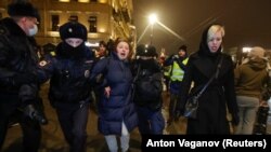 Russian police officers detain a woman during a February 2, 2021 demonstration in Moscow against the sentencing of Russian opposition leader Aleksei Navalny to prison. 