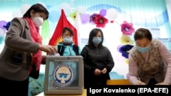 Members of the electoral commission in the Kyrgyz village of Besh-Kungei, near Bishkek, prepare a polling station for Kyrgyzstan's October 4 parliamentary elections.
