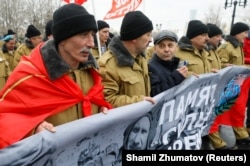 Russian men, including veterans of the USSR's 1979-1989 war in Afghanistan, march during a Moscow ceremony marking the 30th anniversary of the withdrawal of Soviet troops from Afghanistan.