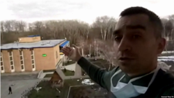 From his balcony, quarantined Ukrainian journalist Oleksandr Makhov shows the Novi Sanzhary's administration building.