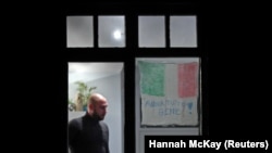 A sign in Italian that reads "Everything will be OK," a phrase that has appeared on banners across Italy as a message of hope amidst the COVID-19 pandemic, hangs in the window of a residential building in Streatham, a suburb of London. 