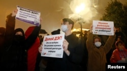 "We're changing a fake democracy for a workers' [democracy!" proclaims one sign held at a September 20, 2020 protest by the Russian Communist Party in downtown Moscow against online voting results that declared the Kremlin-backed United Russia party the city's winning party. 