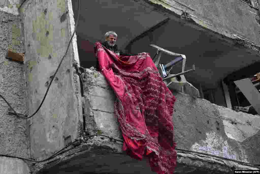 NAGORNO-KARABAKH -- Hrach Vanian, 75, removes debris in his apartment damaged by shelling during the ongoing military conflict between Armenia and Azerbaijan over the breakaway region of Nagorno-Karabakh, in the disputed province&#39;s capital of Stepanakert,