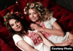 Miss Belarus 2004 (Volha Antropova) and Miss Belarus 2008 (Volha Khizhynkova) in shirts with a traditional Belarusian design.