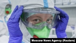 A medical specialist puts on personal protective equipment in Moscow's  RZD-Medicine Central Clinical Hospital, which treats coronavirus patients.  