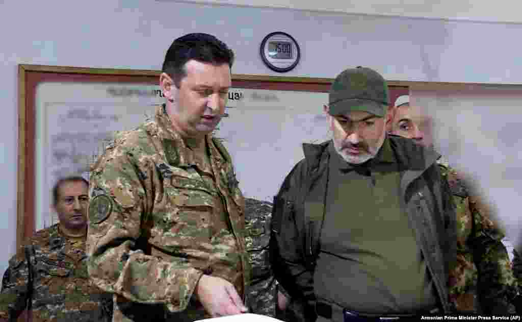 In this photo from the Armenian government, Armenian Prime Minister Nikol Pashinian, right, attends an October 6, 2020 meeting with army commanders in the breakaway Nagorno-Karabakh region. A teenager during the 1988-1994 Karabakh conflict with Azerbaijan, Pashinian, unlike his predecessor, former Prime Minister and President Serzh Sarkisian, a Karabakhi native and commander of the region&#39;s fighters during the initial conflict with Azerbaijan, has no firsthand military experience in the region.&nbsp;