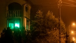 A green light shines in the window of a house in the city of Michalowo, near the Polish-Belarusian border, where an initiative encourages inhabitants to display a green light if they are willing to help migrants in search of food or refuge.