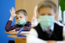 Children attend classes in School #7 in Sakhalin, Russia before self-isolation measures against COVID-19 went into effect.