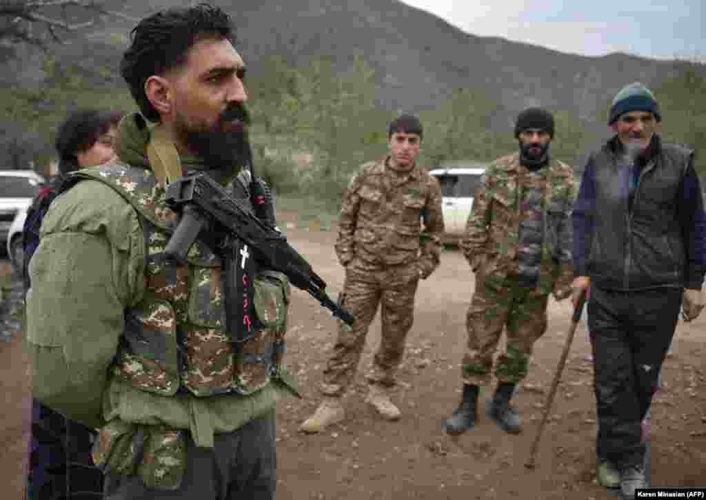 Not all residents of the Lachin region necessarily feel safer because of Russian peacekeeping forces. In the village of Zabukh, near the Lachin Corridor, one volunteer stands at the ready with a Kalashnikov automatic rifle on November 26, 2020. A Twitter video from elsewhere in the district shows an elderly ethnic Armenian woman carrying a rifle ahead of the arrival of Azerbaijani forces on December 1, 2020.&nbsp;