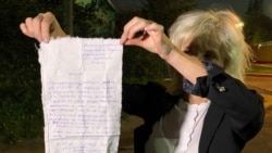 Lawyer Lyudmila Kazak holds up a complaint that one of her clients wrote and handed over to her in Minsk on September 25. Kazak herself was abducted and later found guilty of "failing to obey" police at an opposition rally that she says she didn't even attend.
