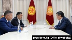 President Sooronbai Jeenbekov (right) meets with Kyrgyzstan's new parliamentary speaker, Kanat Isaev (front left), and prime minister, Sadyr Japarov, in Bishkek on  October 14, 2020.