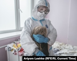 Nurse Polina hugs her patient Veronika.