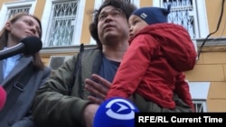 Olga and Dmitry Prokazov with their year-old son, Artyom