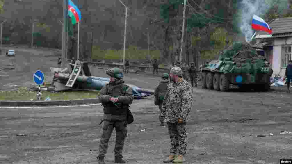 NAGORNO-KARABAKH -- An Azerbaijani service member and a Russian peacekeeper stand guard at a checkpoint on the outskirts of Shushi (Susa) in the region of Nagorno-Karabakh, November 13, 2020