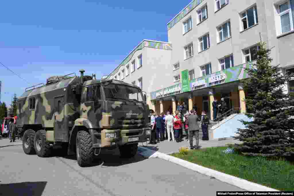Law enforcement officers on May 11, 2021 work outside of Kazan&#39;s School No. 175, where at least nine people were killed and 21 wounded when a suspected 19-year-old gunman opened fire on the facility, according to officials.&nbsp;&nbsp;