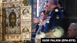 In this photo from the Russian Orthodox Church, Russian Defense Minister Sergei Shoigu (left) attends the June 14, 2020 consecration of the the country's new Cathedral of the Russian Armed Forces outside Moscow. 