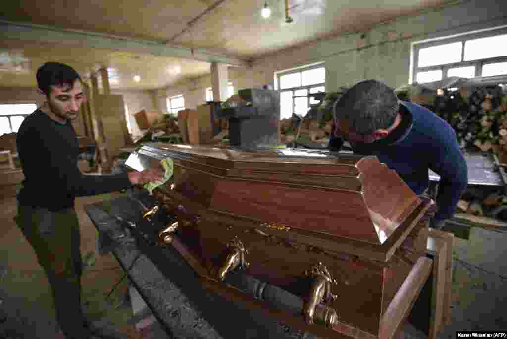 NAGORNO-KARABAKH -- Men make a coffin at a furniture workshop, which totally switched its business to casket production amid the ongoing military conflict between Armenia and Azerbaijan over the breakaway region of Nagorno-Karabakh, in the breakaway  regi