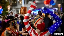 Supporters of former Vice President Joe Biden celebrate in Philadelphia, Pennsylvania on November 7, 2020 after the prognosis that Biden has received sufficient Electoral College votes to become president of the United States. 