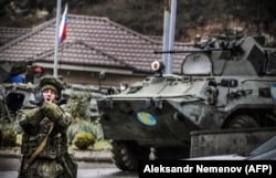 A Russian soldier, part of a peacekeeping force of 1,960 armed forces for Nagorno Karabakh, shouts "No pictures!" at a checkpoint outside the Karabakhi town of Stepanakert on November 13, 2020.