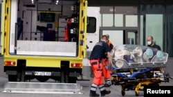 Paramedics load a stretcher into an ambulance that is believed to have transported Russian opposition leader Aleksei Navalny to the Charite -- Universitatsmedizin hospital in Berlin on August 22, 2020. 