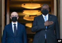 U.S. Defense Secretary Lloyd Austin (right) welcomes Ukrainian Defense Minister Oleksii Reznikov at the Pentagon on November 18, 2021. Their talks included the buildup of Russian troops on Ukraine's eastern border.