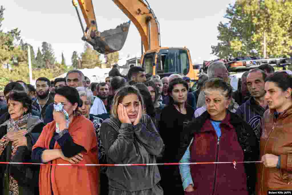 One day after a Russia-brokered ceasefire between Armenia and Azerbaijan went into effect on October 10, 2020, residents of the Azerbaijani city of Ganja watch as rescuers search for victims or survivors of a rocket strike.&nbsp;Although it lies outside of the Karabakh conflict zone, Ganja, which houses the Azerbaijani Air Force, has come under steady attack recently.&nbsp;